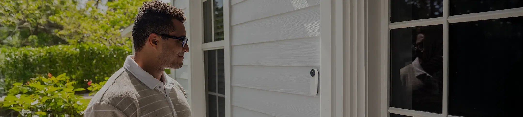 man looking at ADT doorbell camera